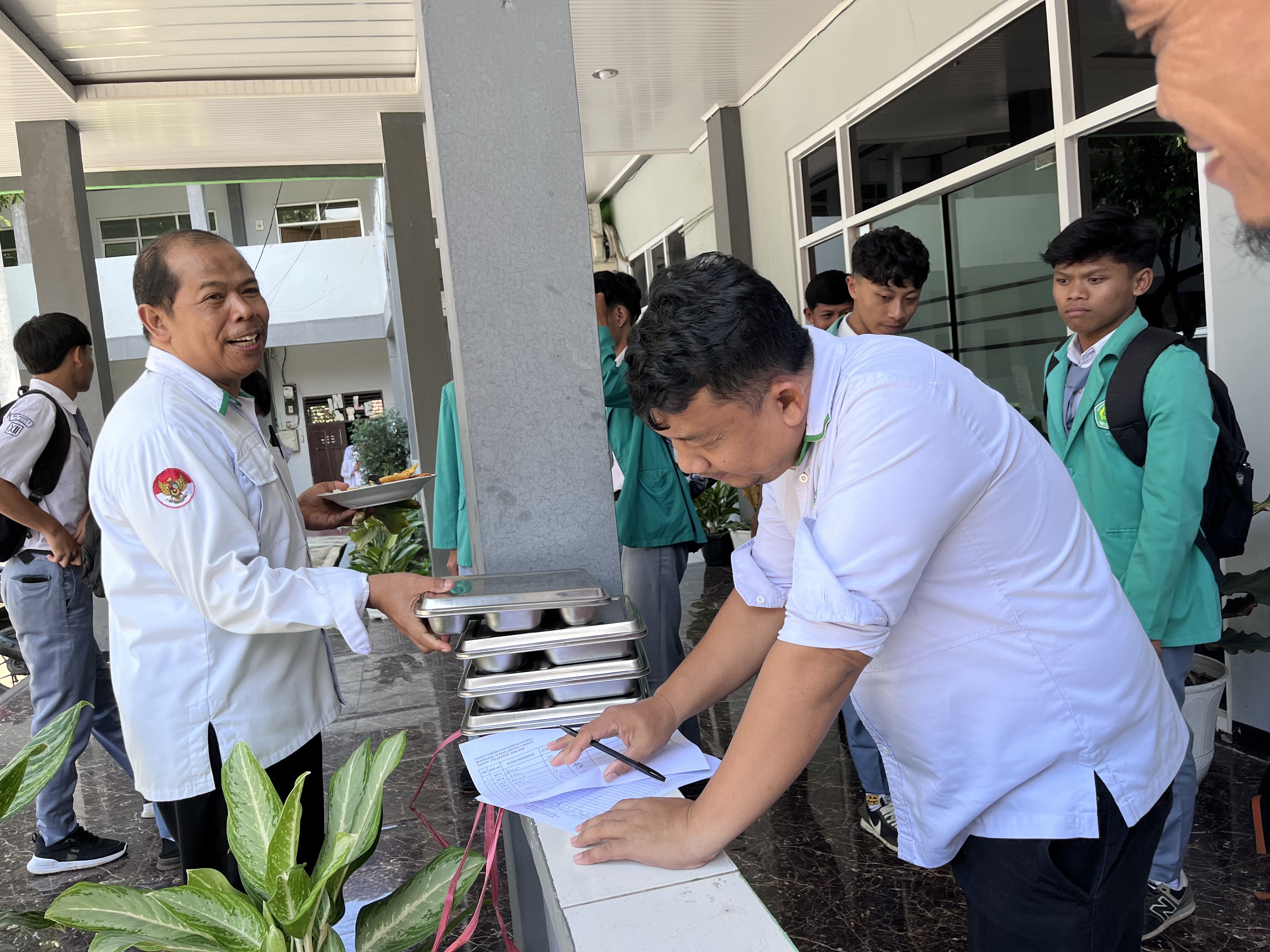 Petugas Salurkan Makan Bergizi Gratis untuk Siswa Kelas XII